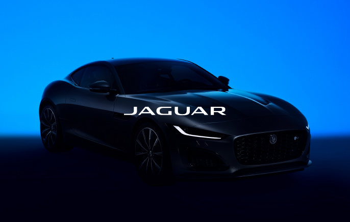 A Jaguar F-TYPE that is backlit with a blue light,